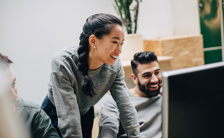 Two people looking at a computer.