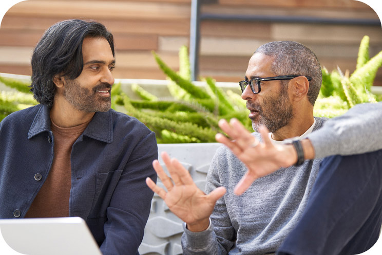 Two people conversing in an outdoor workspace