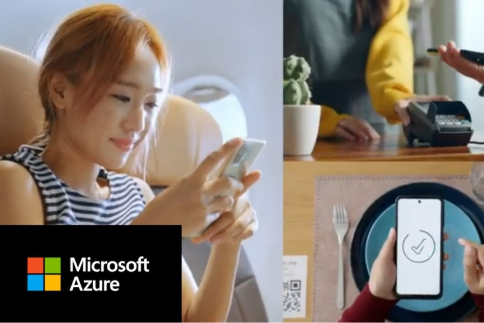 A person with their phone and at a credit card terminal.