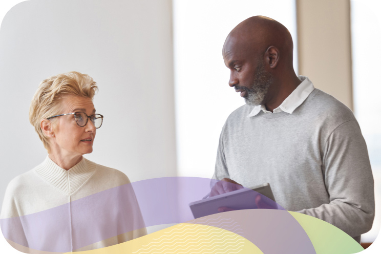 Two people looking at each other discussing work