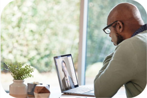 A person participates in a webinar on their laptop.