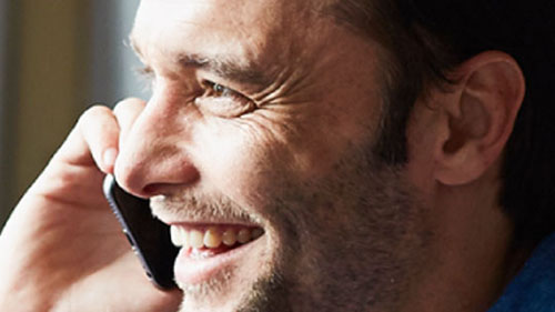 Man smiling talking on cell phone
