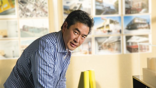 A man works in front of many images