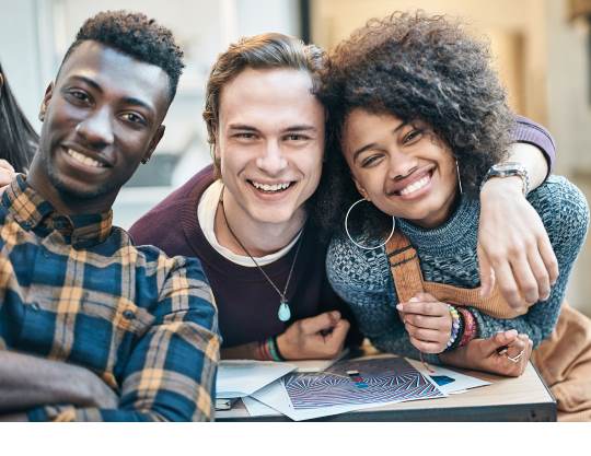 Three individuals smiling at the camera