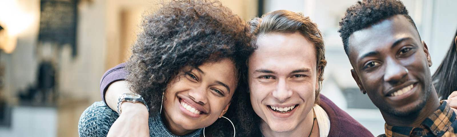Three individuals smiling at the camera