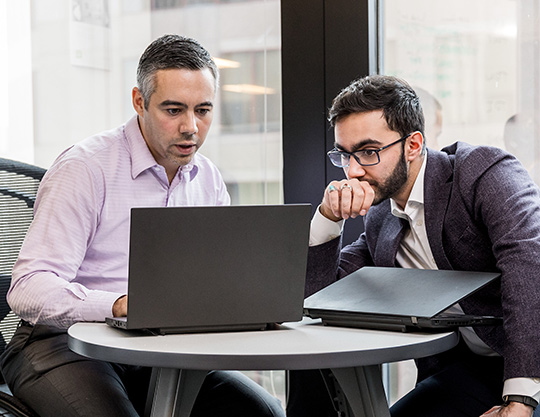 Two people looking at computer