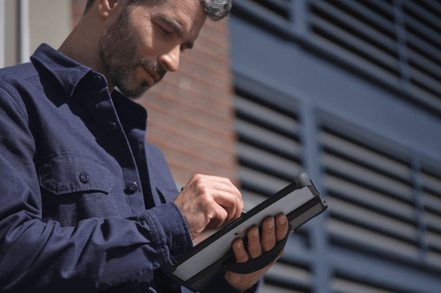 A person using a stylus on a tablet computer