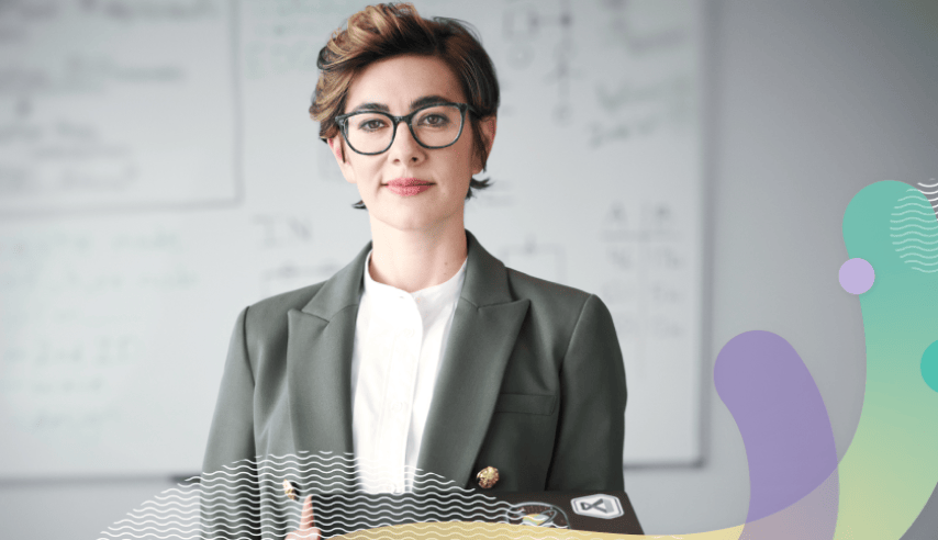 A person in a suit holding a laptop