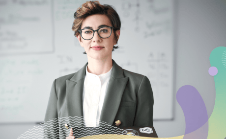 A person in a suit holding a laptop