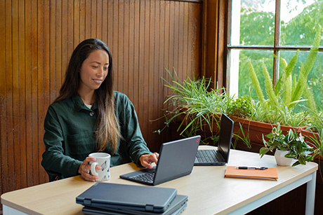 An associate working in an architectural design firm in front of laptop