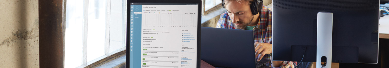 Person with headphones working on computer