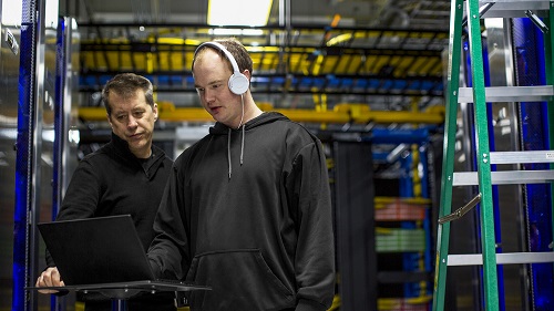 Two people working together in a datacenter