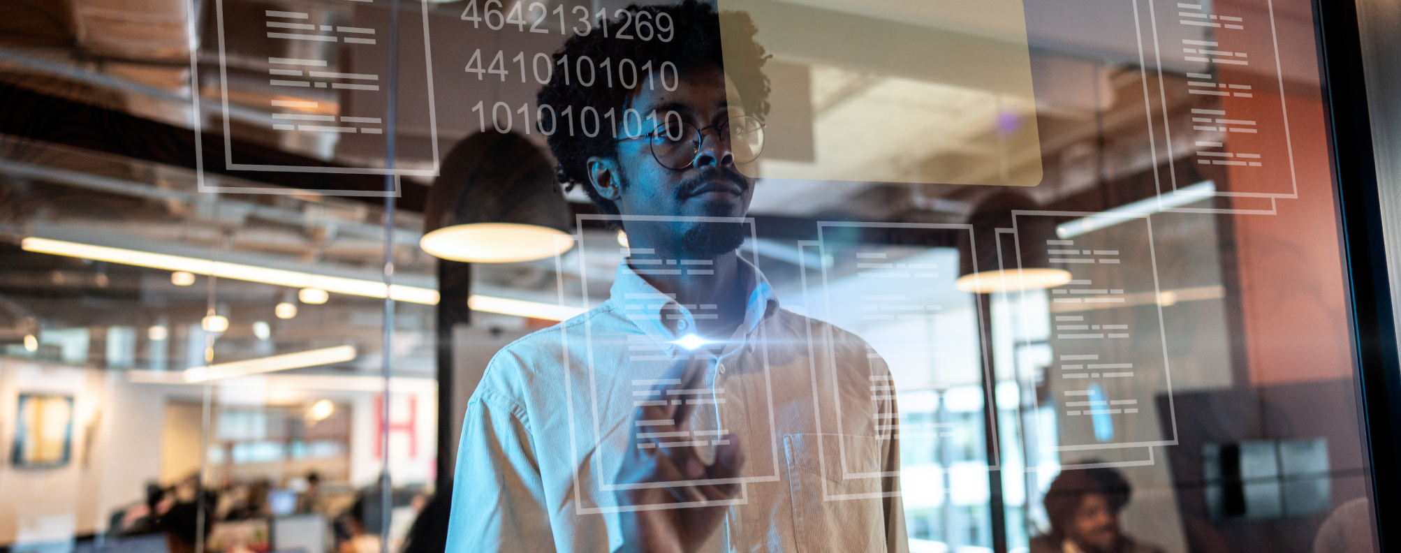 A person interacts with virtual data and file icons on a transparent screen in a modern office setting.
