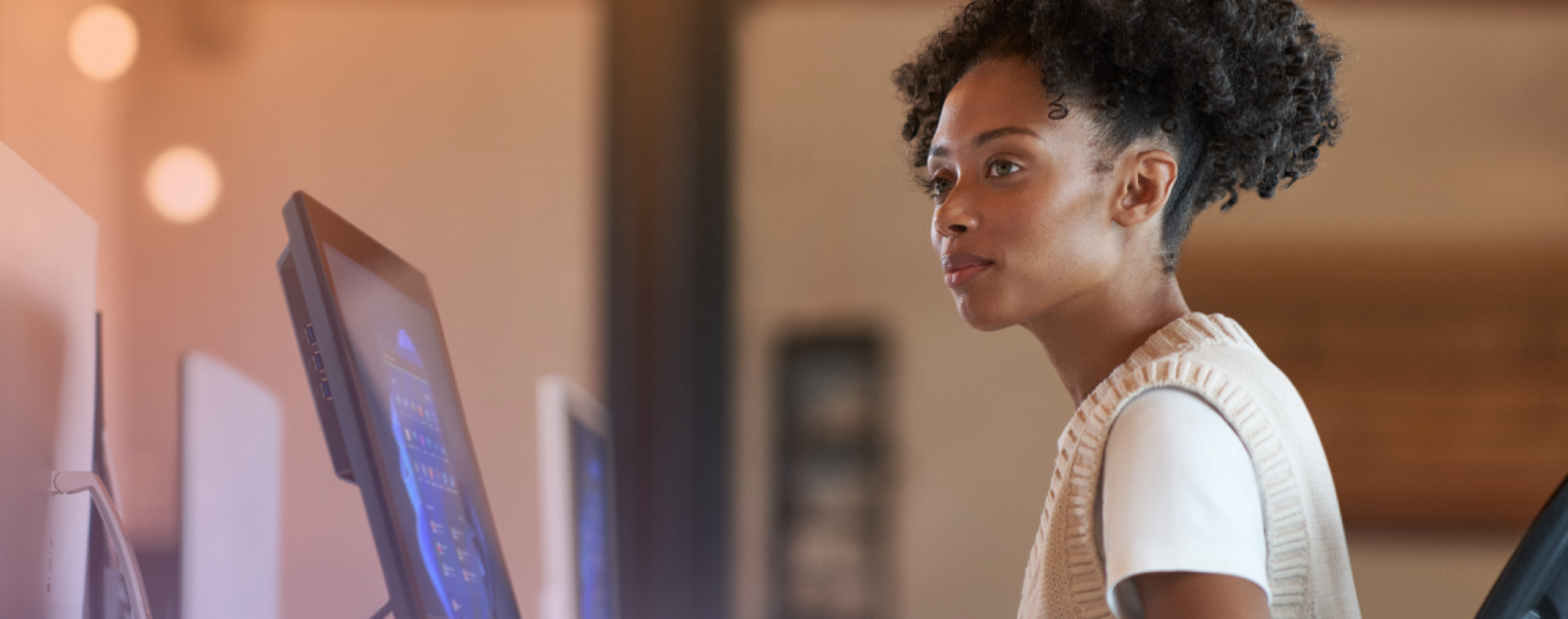 Person sitting in front of a desktop computer