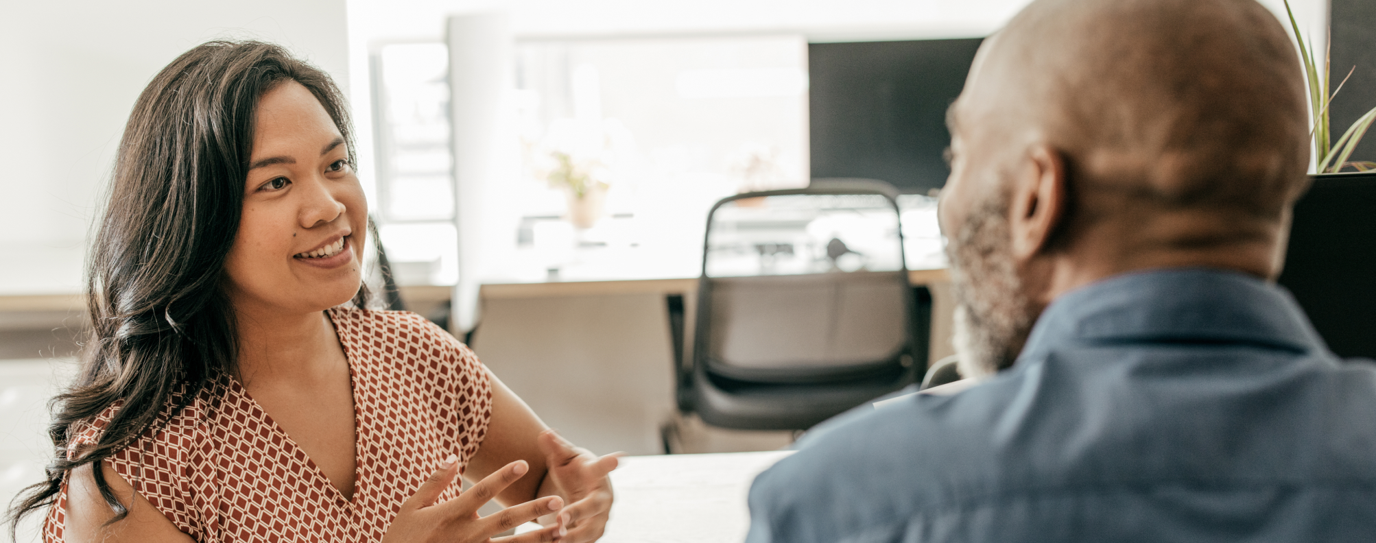 Two people in an office having a discussion