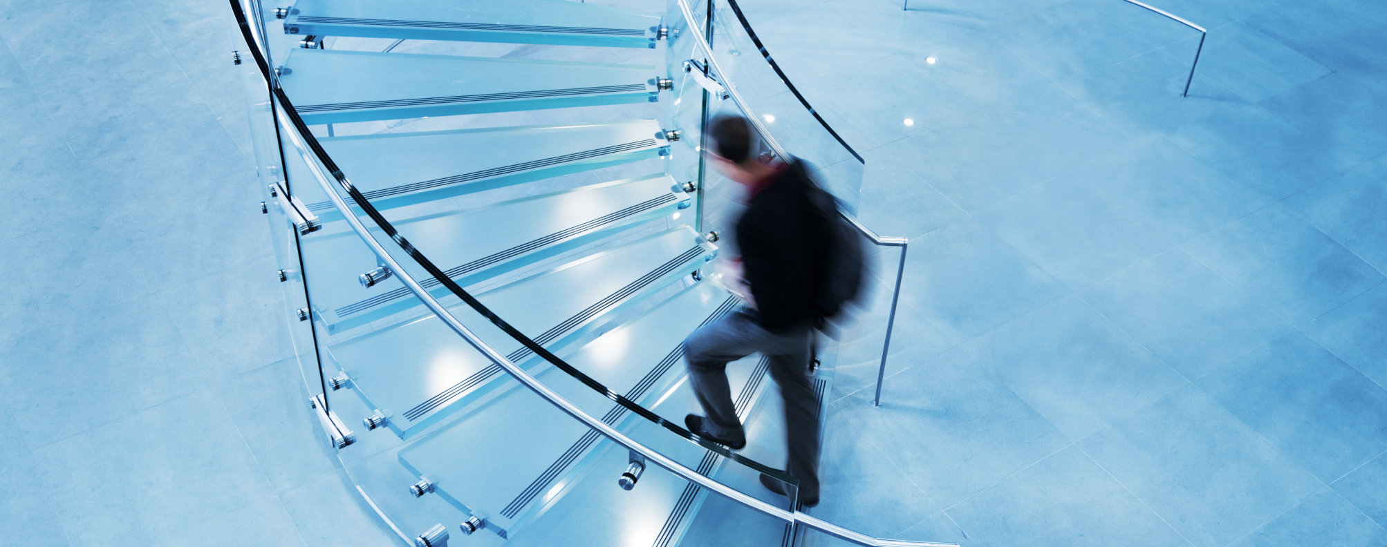 A person walking up a spiral staircase.