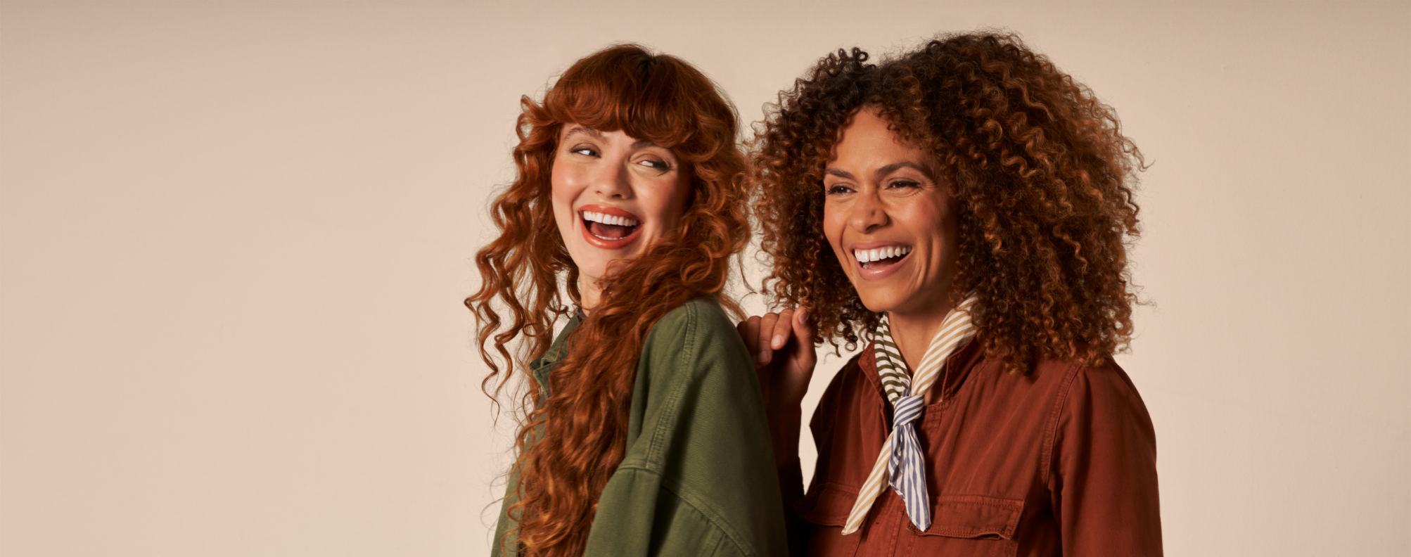 Two women laughing together.