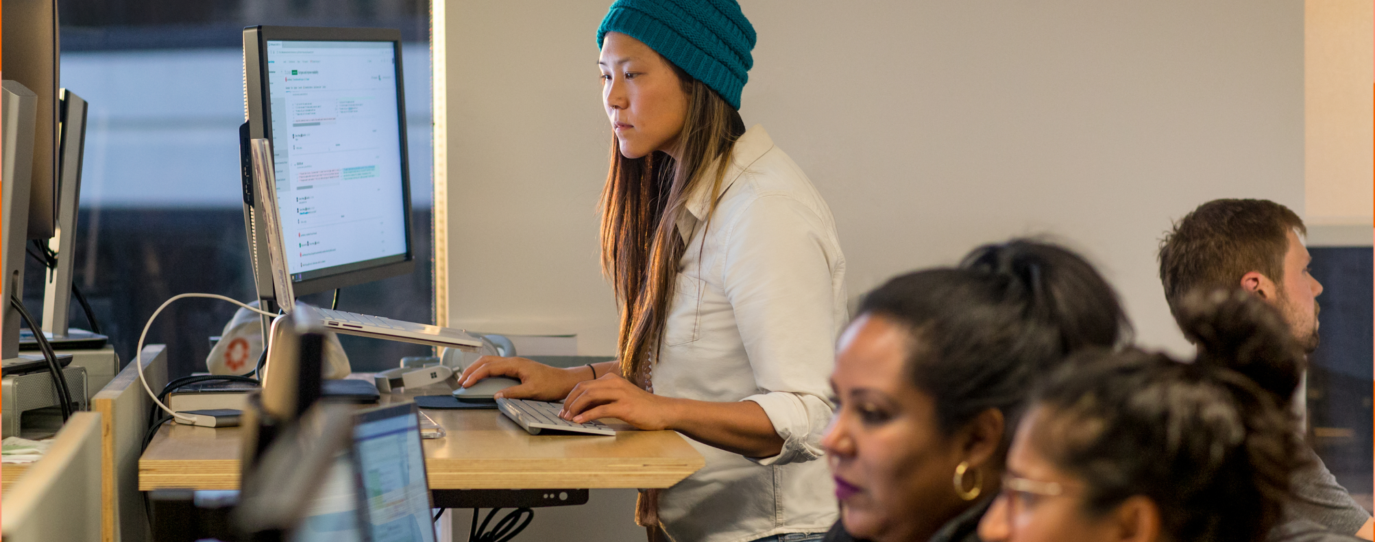 person working at a computer in an open space office