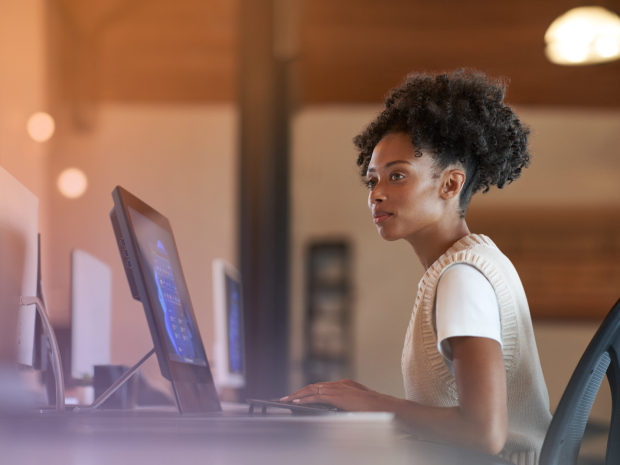 Person sitting in front of a desktop computer