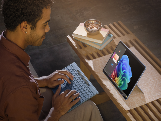 Man typing on a Microsoft Surface tablet's external keyboard