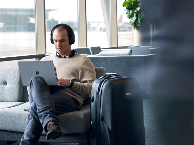 person working on a laptop in a business lounge