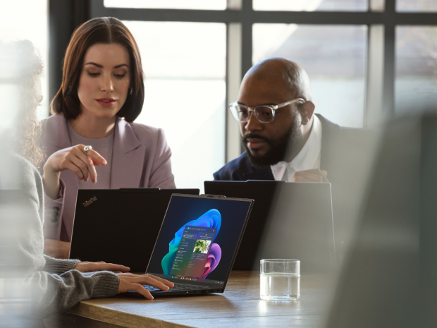 Business people working on laptops and collaborating.