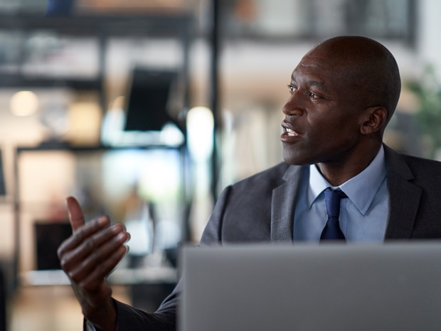 A legal professional gesturing in a meeting