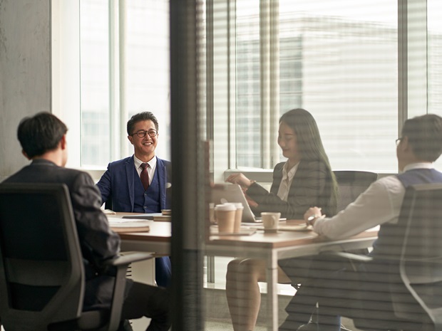 A group of businesspeople collaborating around a conference room table