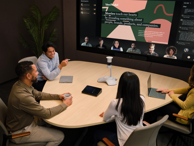 People in a conference room watching a presentation.