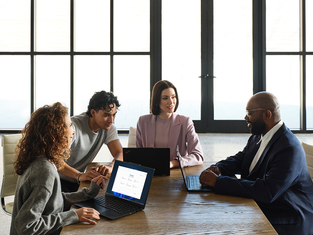 Team collaborating at table.