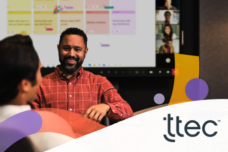 Two people sitting at a conference table.