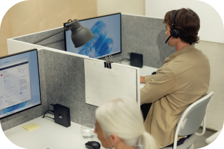 People working in call center cubicles.