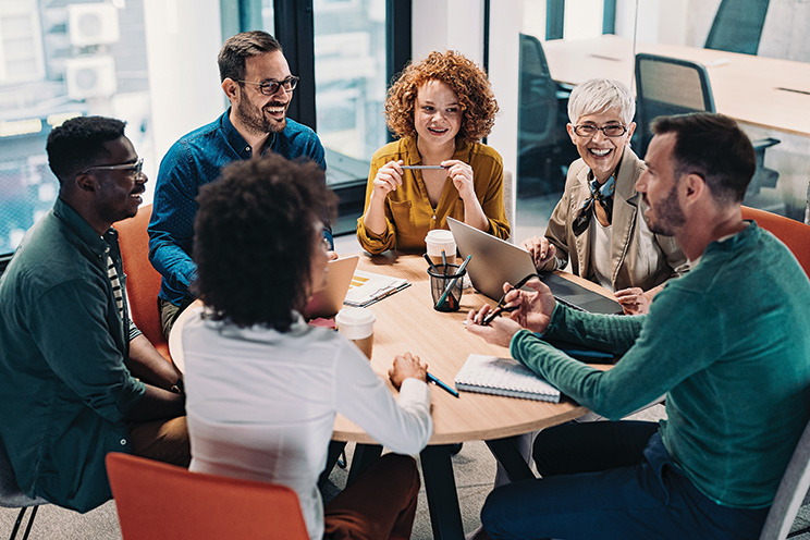 A group of people seated around a conference table