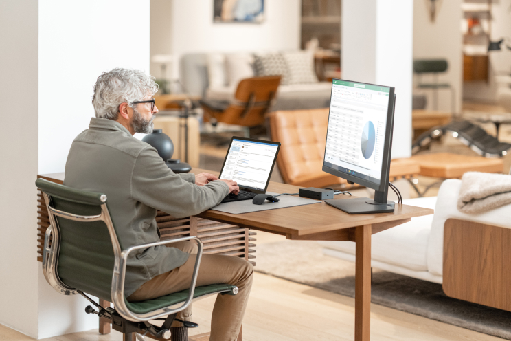 A person sits at a desk working on a computer