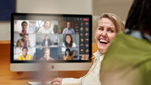 A person laughing while on a video call
