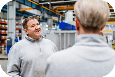 Two people talking in a warehouse