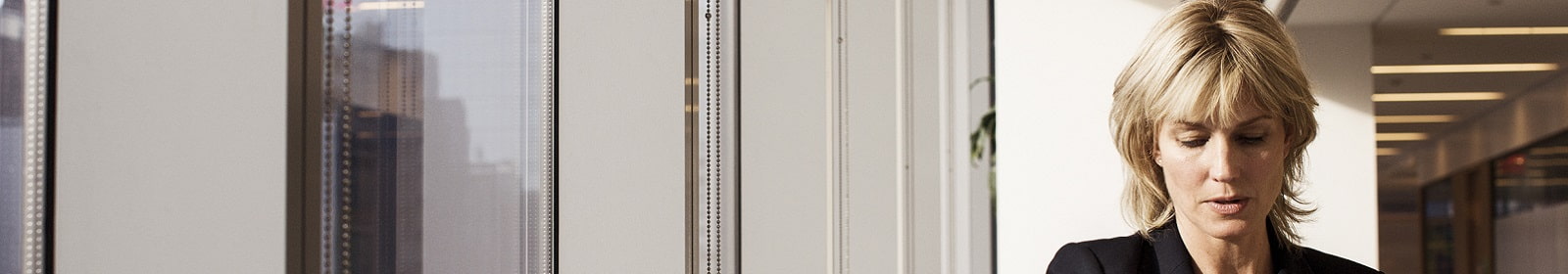 A businesswoman works by a window