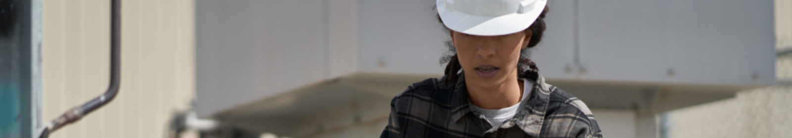 Field engineer inspects electrical substation on a wind farm using remote assist on a Surface tablet