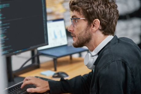 Person at a desk with a keyboard and monitor