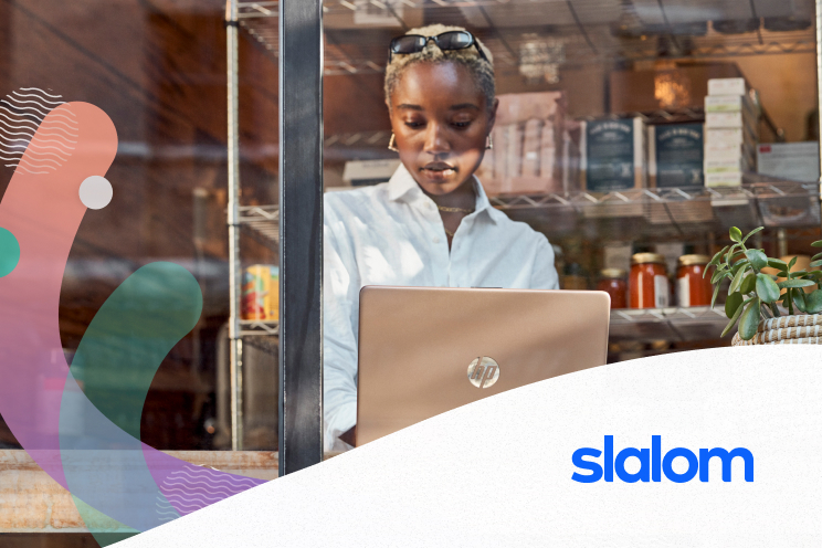 A person working at a laptop ledge in a shop