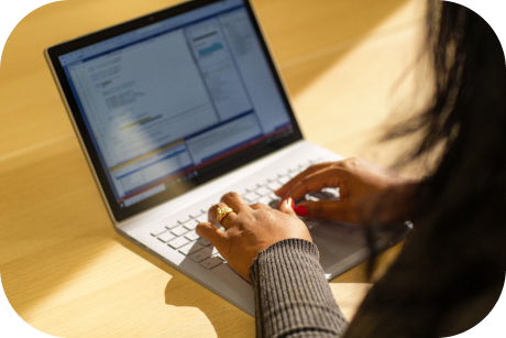 A person types on a laptop keyboard