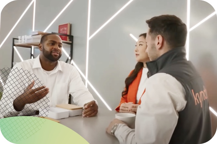 Three people sitting around a table