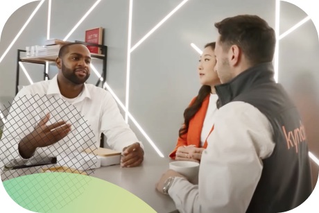 Three people sitting around a table