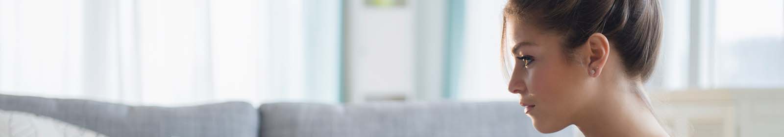 A woman sits in profile looking to the left