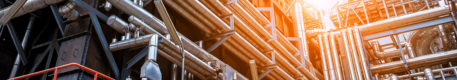 A series of horizontal and vertical pipes at an oil refinery