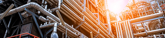 A series of horizontal and vertical pipes at an oil refinery