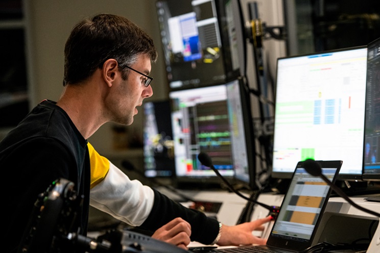 A worker monitors several screens