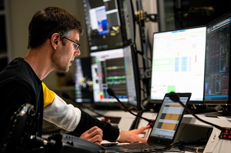 A worker monitors several screens