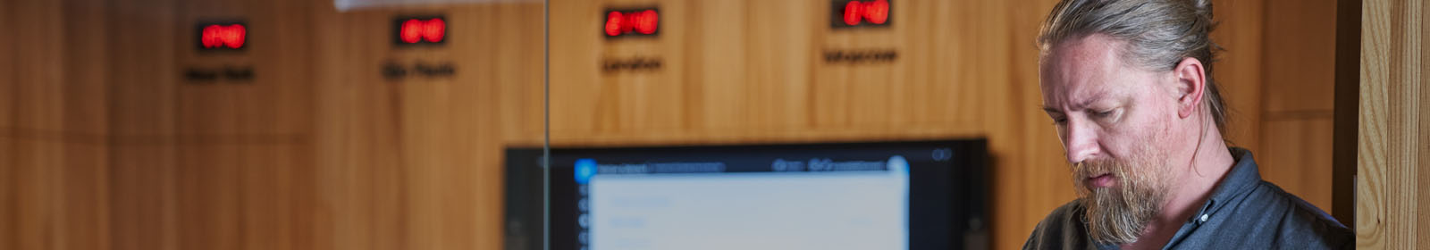 Person looking down with clocks in the background