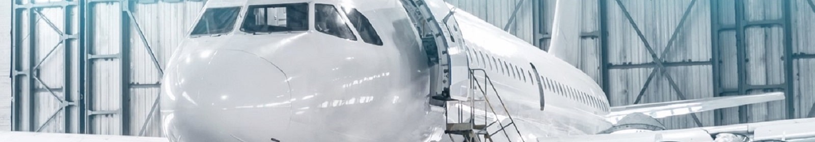 Lights illuminate an airplane in a hangar